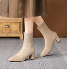 Mescini apricot knit square toe sock ankle boots, worn indoors under a brown skirt, US women's sizes