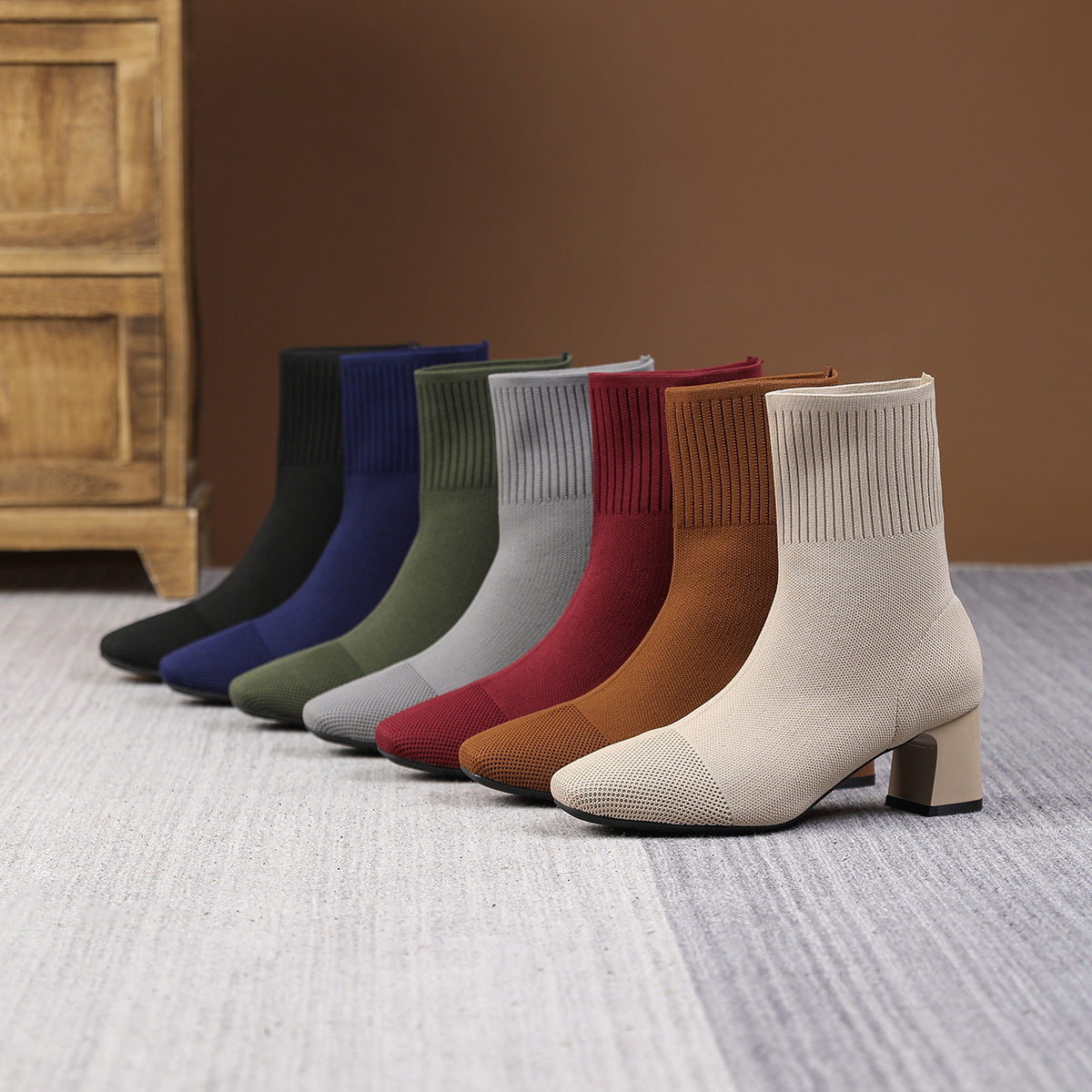 Mescini – seven knit sock ankle boots lined up in a row, full view, US women's sizes