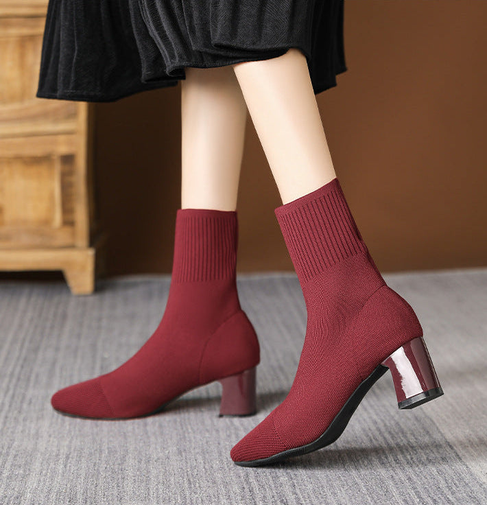 Mescini burgundy knit square toe sock ankle boots, worn mid stride under a black skirt, US women's sizes