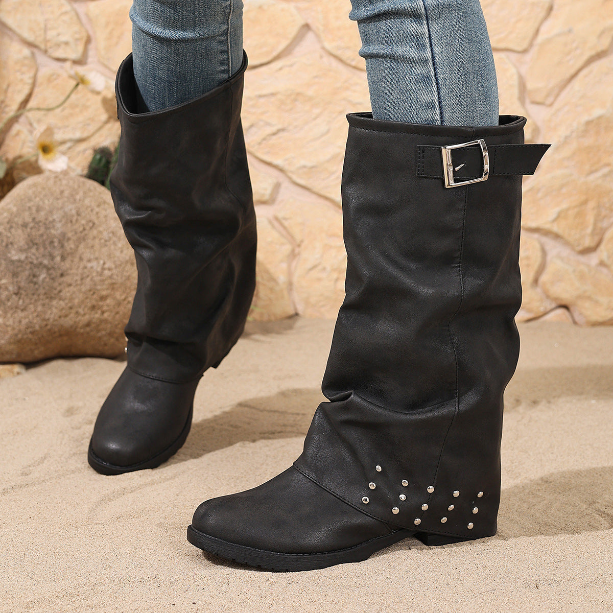 Mescini black fold over slouch boots standing in sand with the buckle up, US women's sizes
