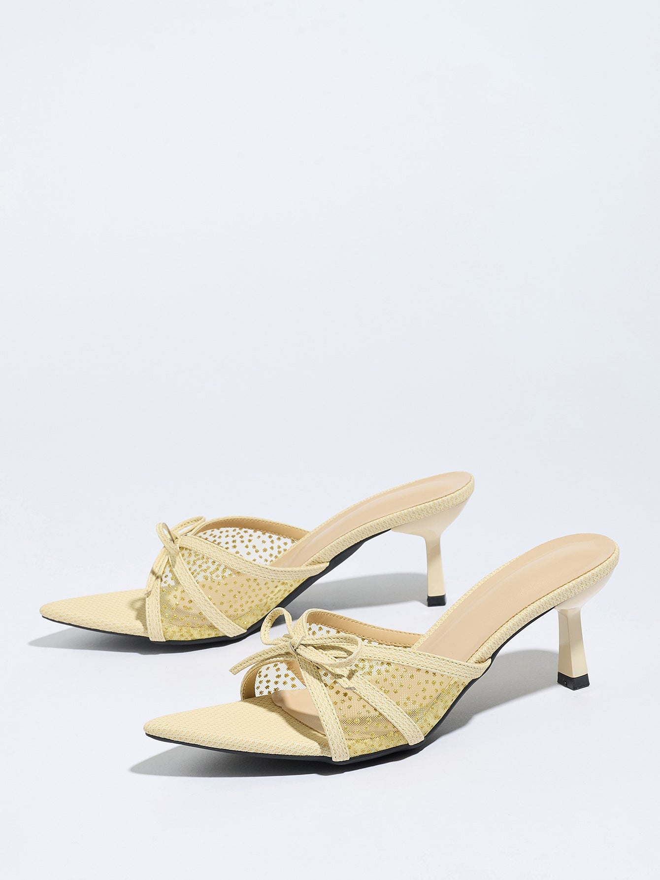 Mescini apricot bow mesh pointed toe mule heels, the pair angled on a white ground, US women's sizes