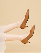 Mescini brown knit pointed toe kitten heel pumps, worn with both legs raised, US women's sizes