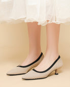 Mescini beige knit pointed toe kitten heel pumps, worn standing under a white hem, US women's sizes