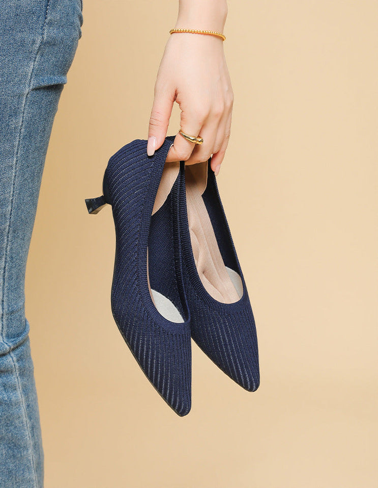 Mescini navy knit pointed toe kitten heel pumps, held in one hand beside jeans, US women's sizes