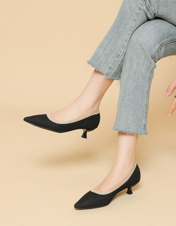 Mescini black knit pointed toe kitten heel pumps, worn with jeans and legs crossed, US women's sizes