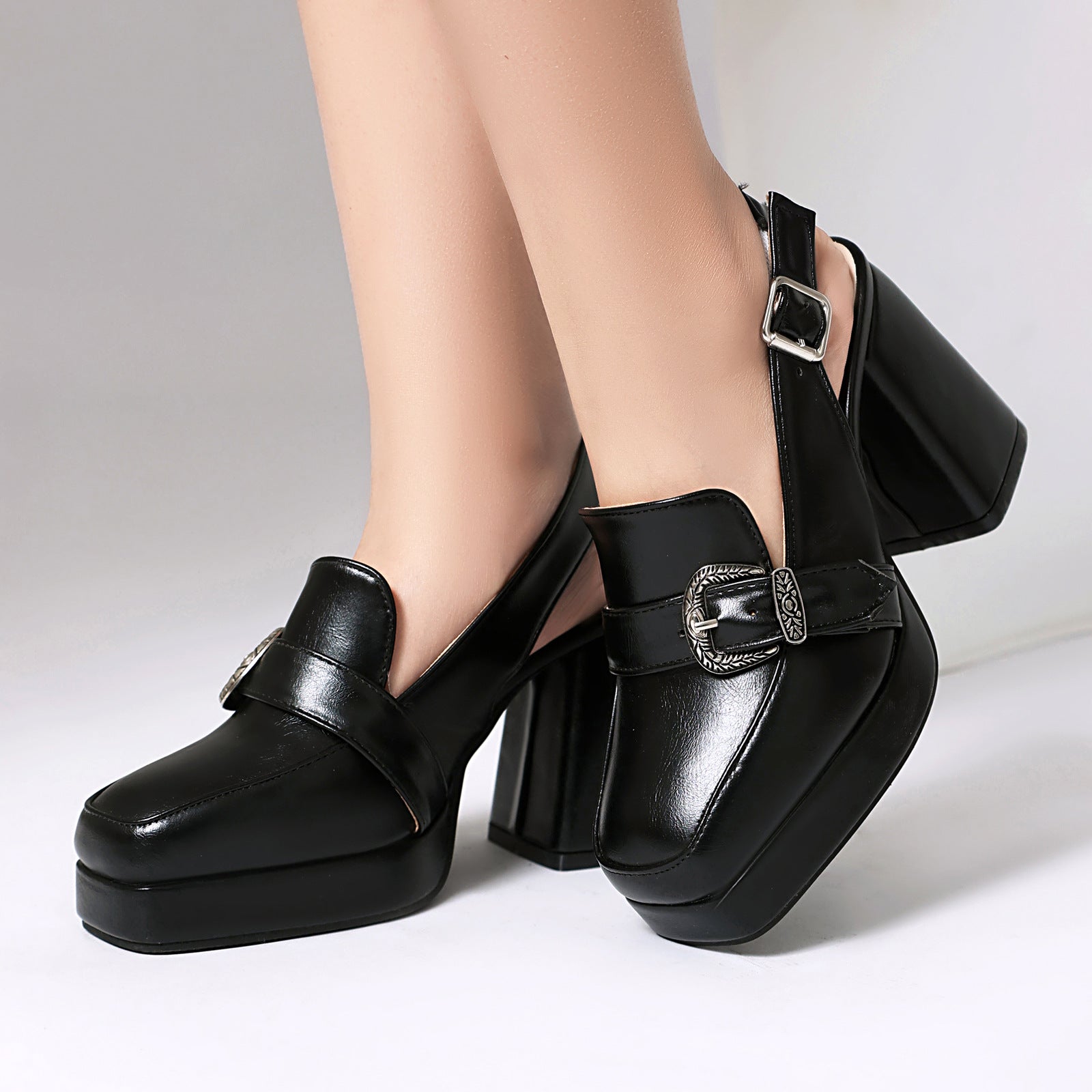 Mescini black square toe platform slingback loafers, worn close up, one foot forward, US women's sizes