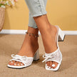 Mescini white square toe block heel mules, worn with cropped jeans, front view of both feet, US women's sizes
