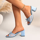 Mescini blue square toe block heel mules, worn with one foot lifted, side view, US women's sizes