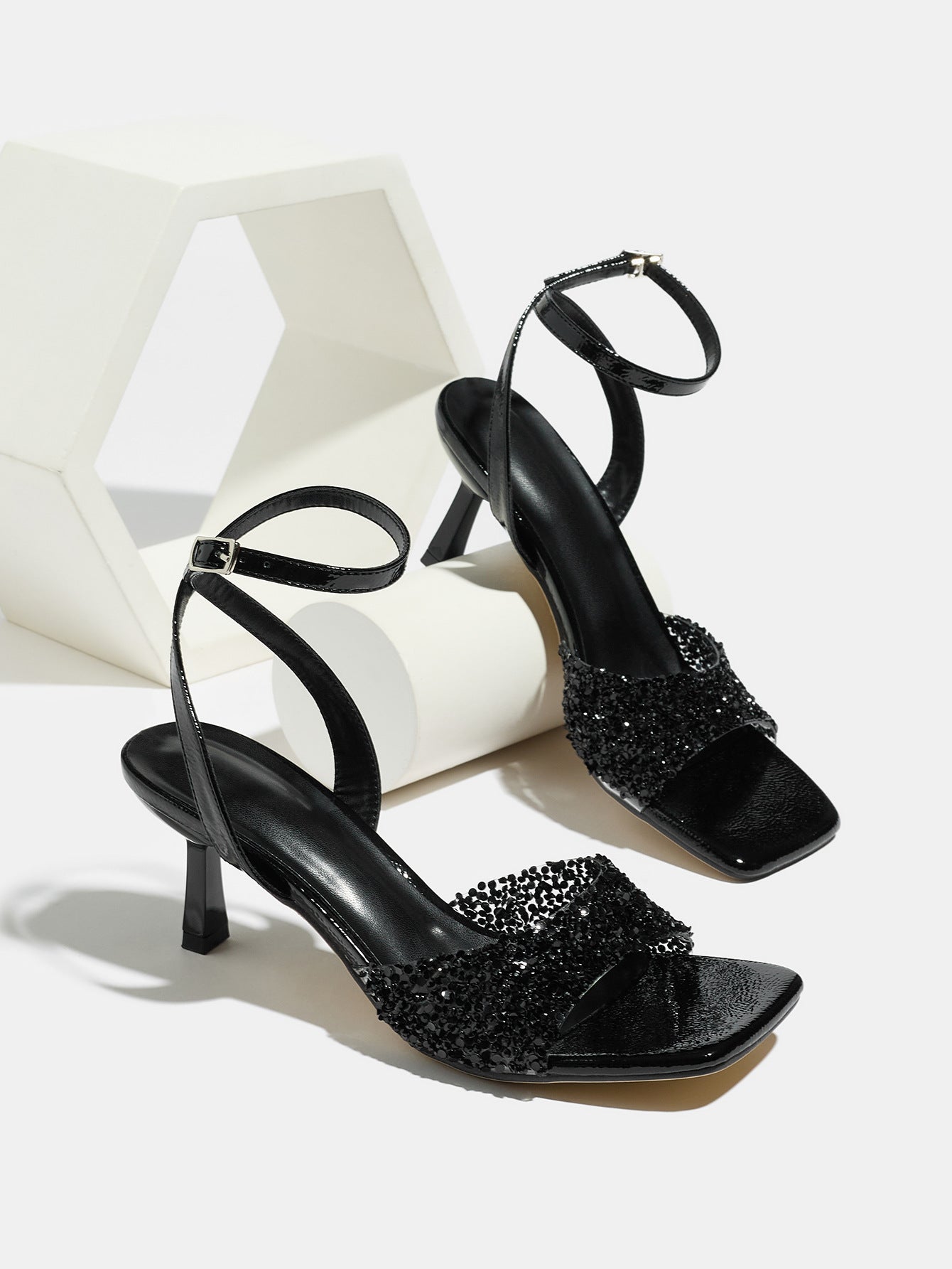Mescini black rhinestone square toe heeled sandals, pair set on a white display block, US women's sizes