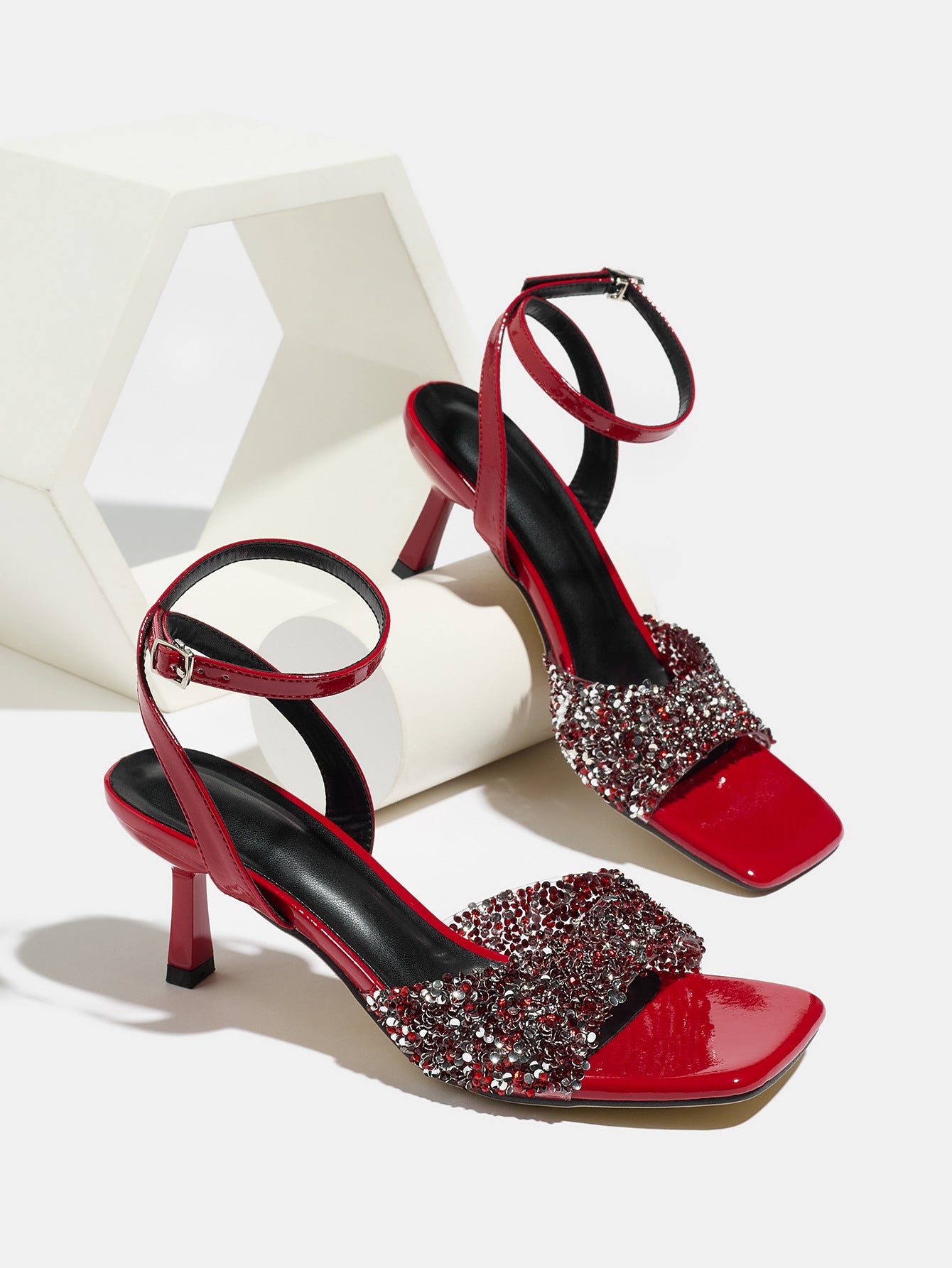Mescini red rhinestone square toe heeled sandals, pair posed on a white display block, US women's sizes