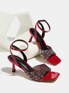 Mescini red rhinestone square toe heeled sandals, pair posed on a white display block, US women's sizes