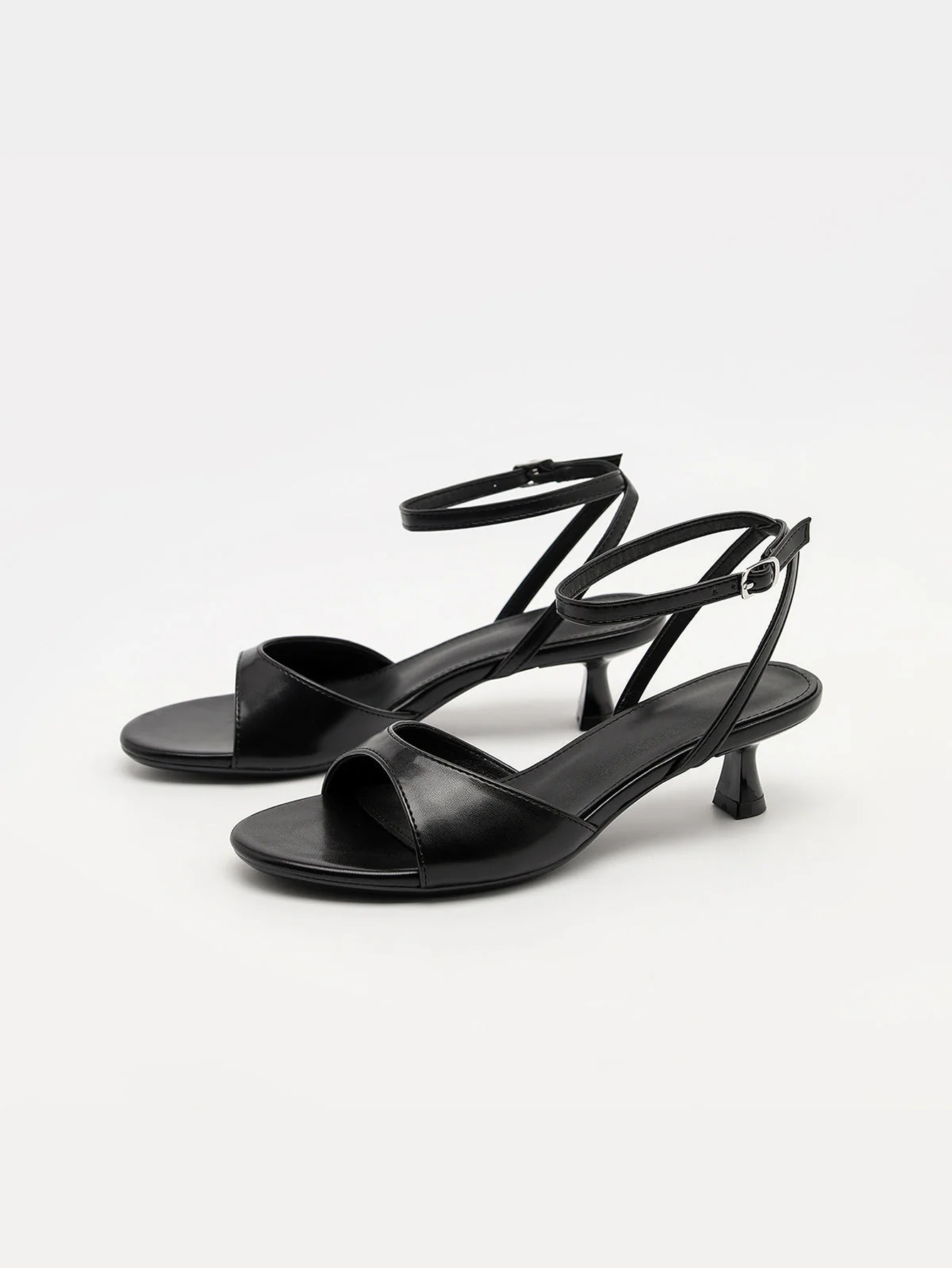 Mescini black ankle strap kitten heel sandals, pair seen at a low angle, US women's sizes