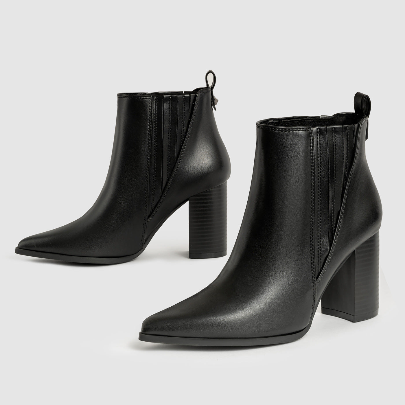 Mescini black chelsea booties, pair on grey showing the stacked block heel and pull tab