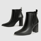 Mescini black chelsea booties, pair on grey showing the stacked block heel and pull tab