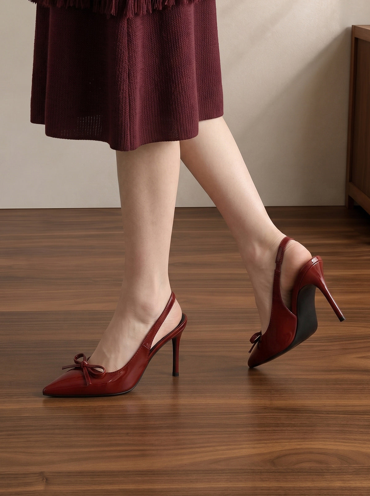Mescini wine red patent bow slingback heels seen close up mid step, US women's sizes