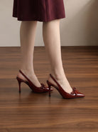 Mescini wine red patent bow slingback heels worn standing, side angle view, US women's sizes