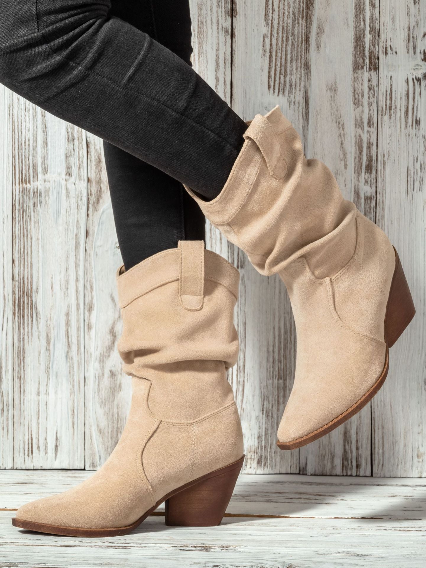 Mescini apricot slouch suede western cowboy boots, worn with dark jeans, standing pose, US women's sizes