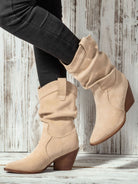 Mescini apricot slouch suede western cowboy boots, worn with dark jeans, standing pose, US women's sizes