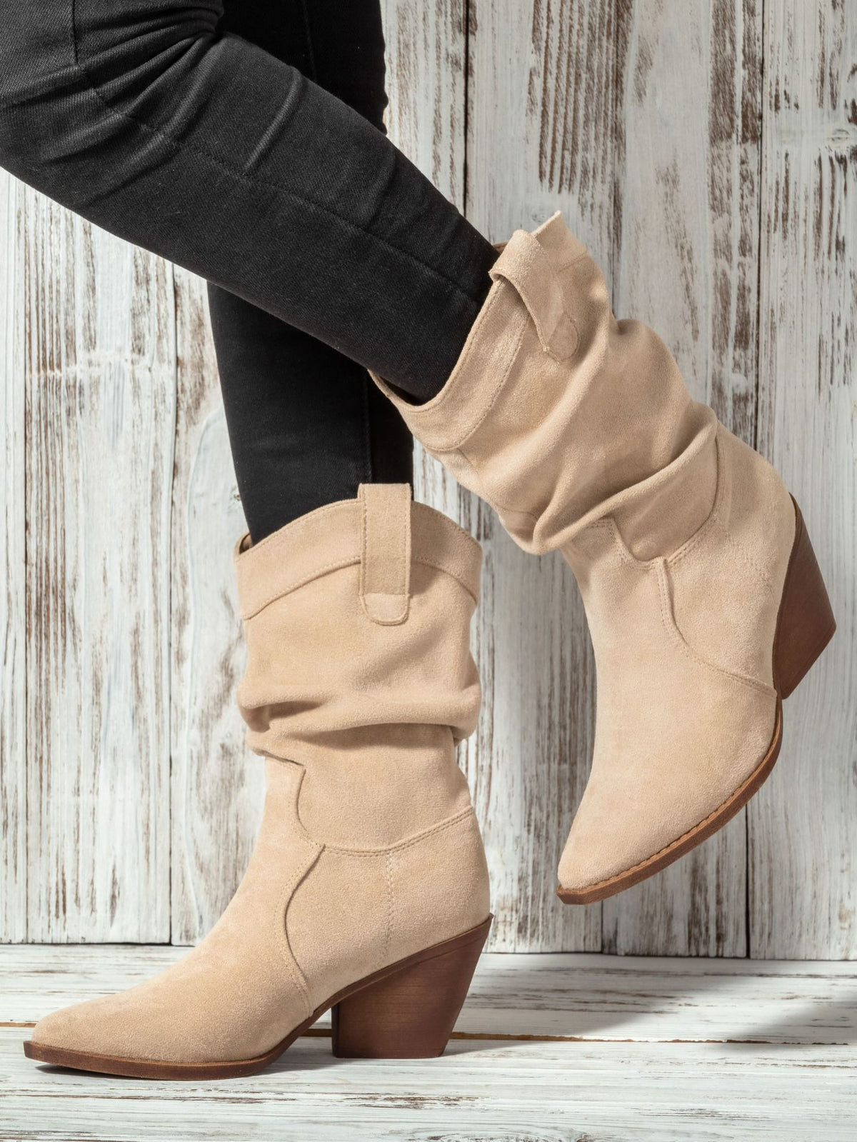 Mescini apricot slouch suede western cowboy boots, worn with dark jeans, standing pose, US women's sizes