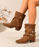 Mescini brown ruched buckle mid calf slouch boots worn with one toe forward, US women's sizes