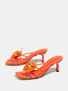 Mescini apricot square toe heeled mule sandals, angled pair on a grey floor, US women's sizes