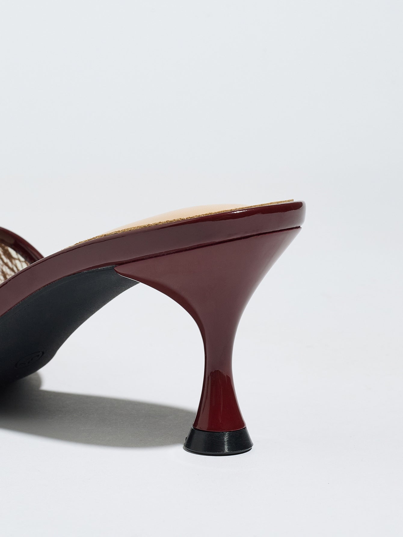Mescini burgundy sheer lace pointed toe mule heels, close up of the curved slim stiletto, US women's sizes