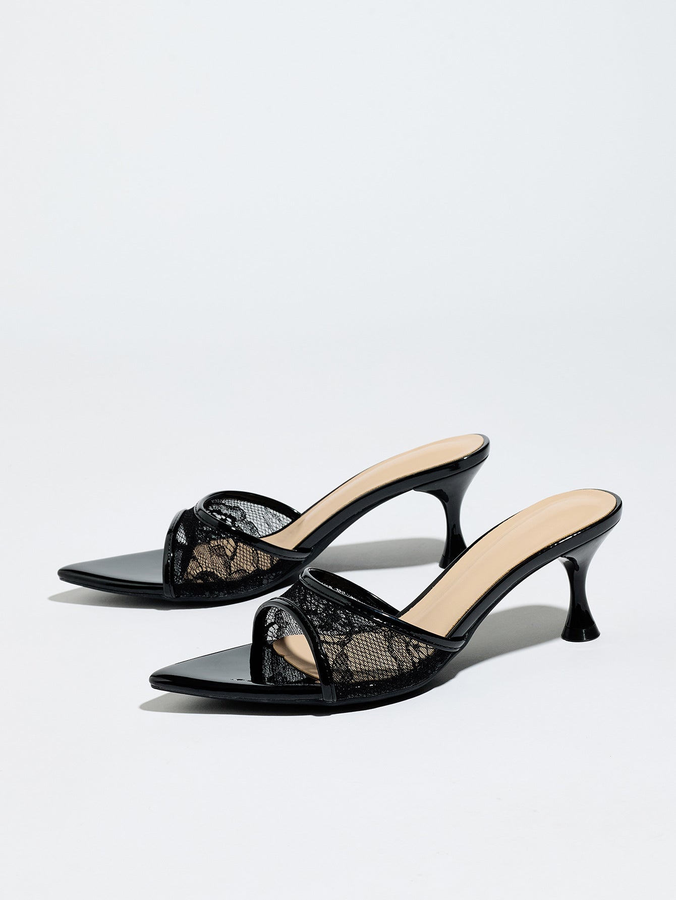 Mescini black sheer lace pointed toe mule heels, angled pair on a light grey surface, US women's sizes