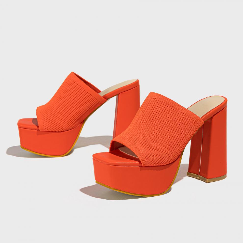 Mescini orange knit band platform mule heels, angled pair on a grey backdrop, US women's sizes
