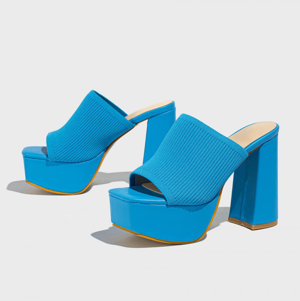 Mescini blue knit band platform mule heels, angled pair on a grey studio backdrop, US women's sizes