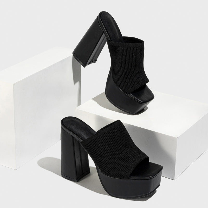 Mescini black knit platform mules staged on white blocks in a pair, US women's sizes