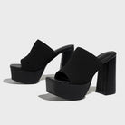 Mescini black knit band platform mule heels, angled pair on a plain grey background, US women's sizes