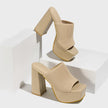 Mescini beige knit band platform mule heels, pair propped on white display blocks, US women's sizes
