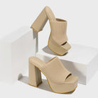 Mescini beige knit band platform mule heels, pair propped on white display blocks, US women's sizes