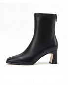 Mescini black square toe stretch ankle boot side view with scooped curved block heel