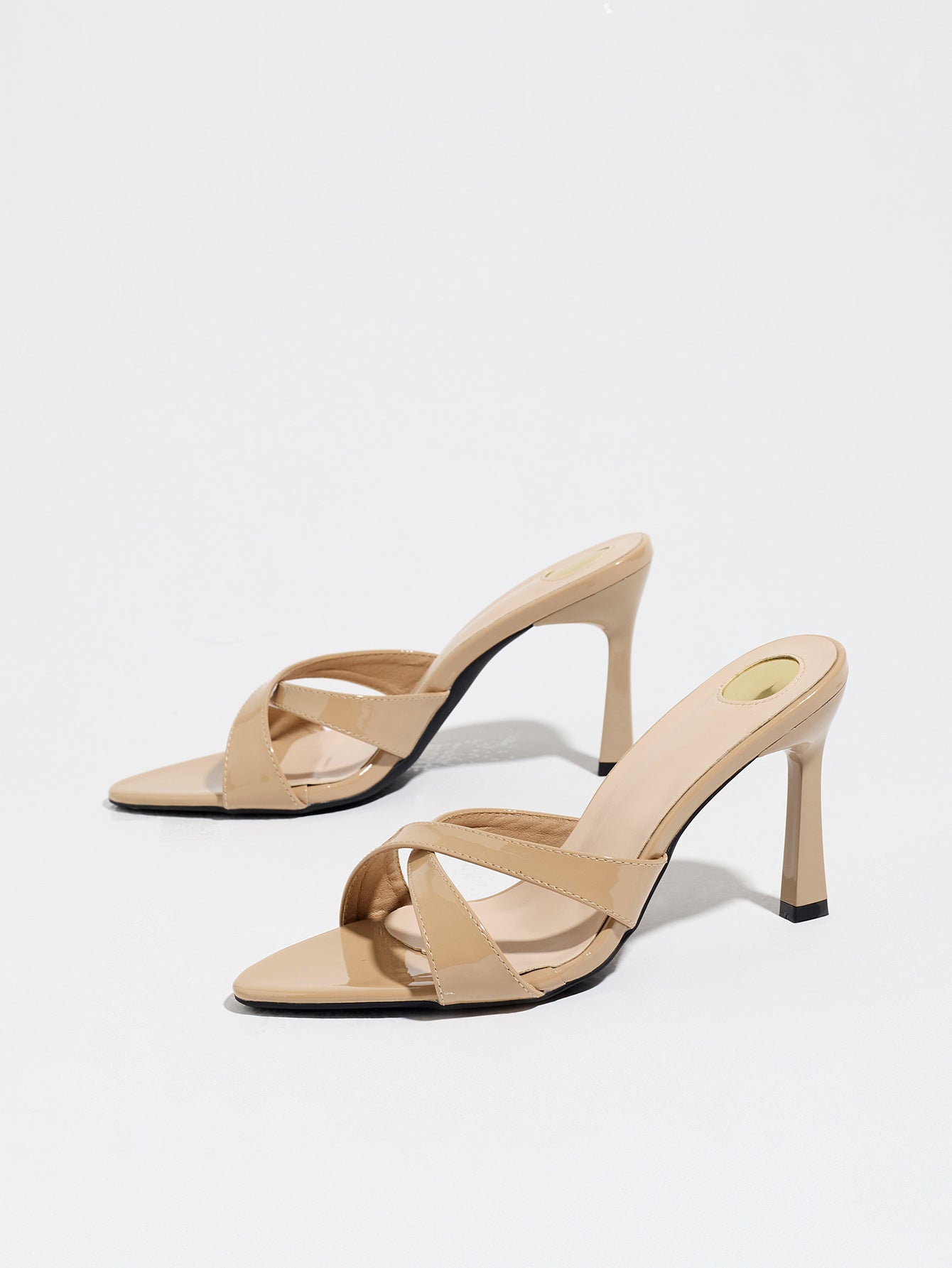 Mescini nude cross strap stiletto mule sandals, pair from a low front angle, US women's sizes