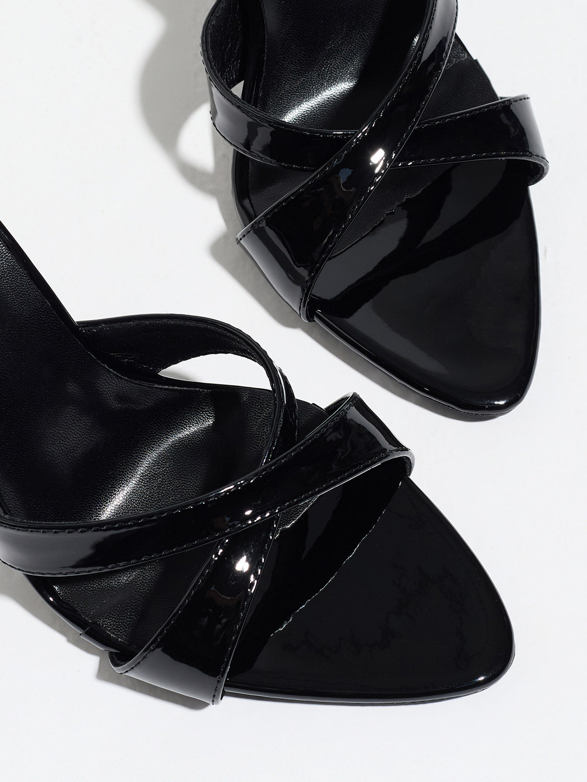 Mescini black cross strap stiletto mules, close up of the crossed patent bands, US women's sizes