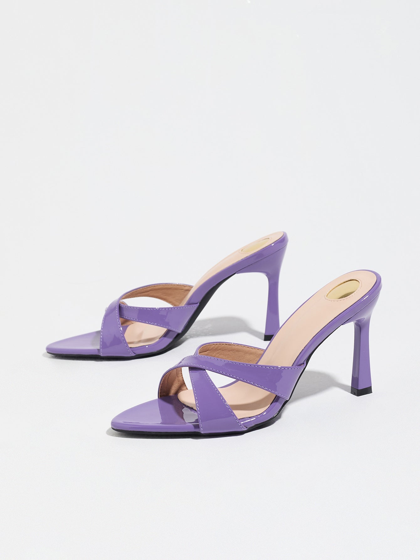Mescini purple cross strap stiletto mule sandals, pair angled on a white ground, US women's sizes