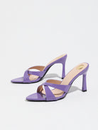 Mescini purple cross strap stiletto mule sandals, pair angled on a white ground, US women's sizes