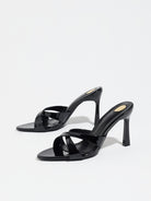 Mescini black cross strap stiletto mule sandals, pair angled on a white backdrop, US women's sizes