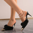 Mescini black faux fur pointed toe stiletto mules, worn on both feet, side profile, US women's sizes