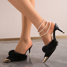 Mescini black faux fur pointed toe stiletto mules, worn on both feet, side profile, US women's sizes