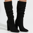 Mescini - black pointed toe tall boots worn on the model, gathered shaft, US women's sizes