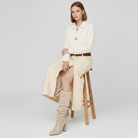 Mescini - beige slouch boots worn seated with a cream skirt, lifestyle view, US women's sizes