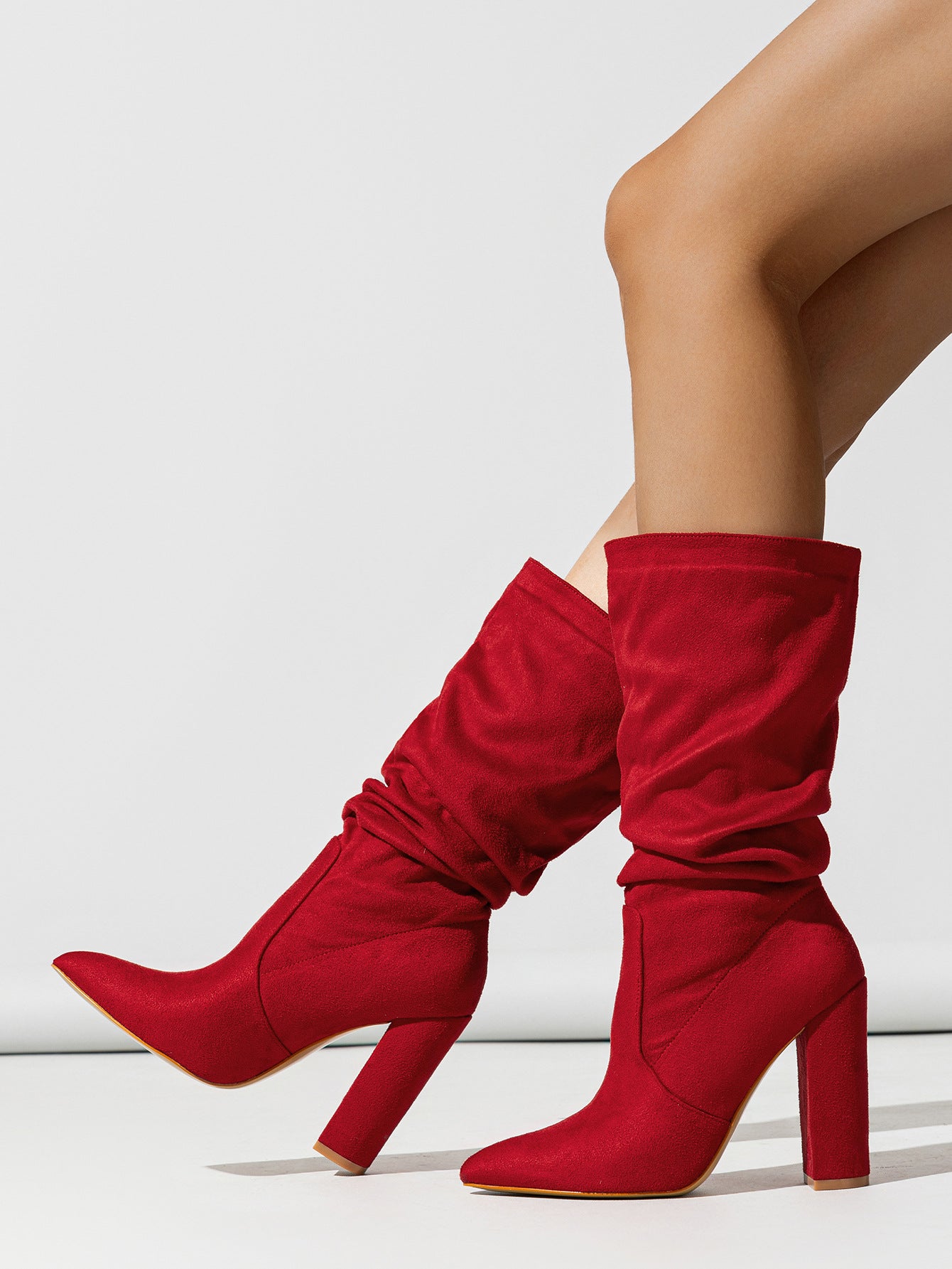 Mescini red slouchy suede knee high boots worn on the model's legs, US women's sizes