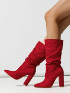 Mescini red slouchy suede knee high boots worn on the model's legs, US women's sizes